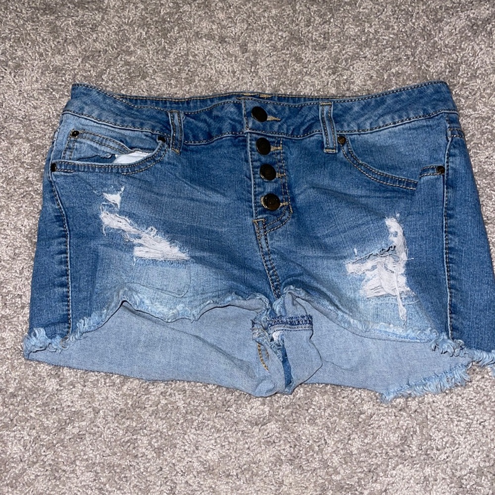 Distressed jean shorts worn buttons